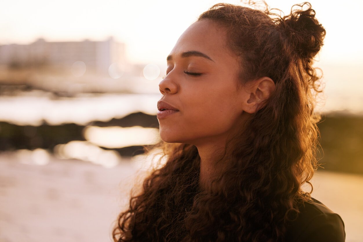 attractive woman meditating, traits of an intuitive empath