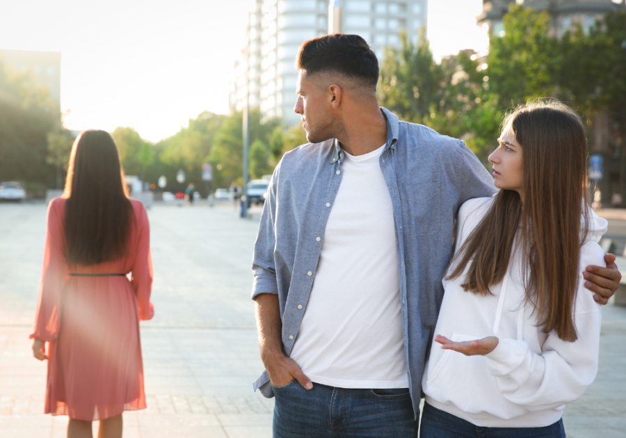 man checking out other woman while with girlfriend signs he's not into you