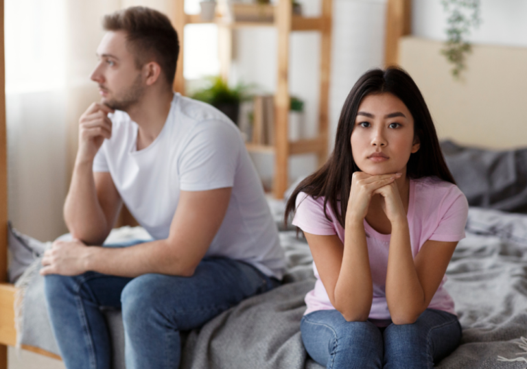 man and woman sitting far away from each other signs he never loved you