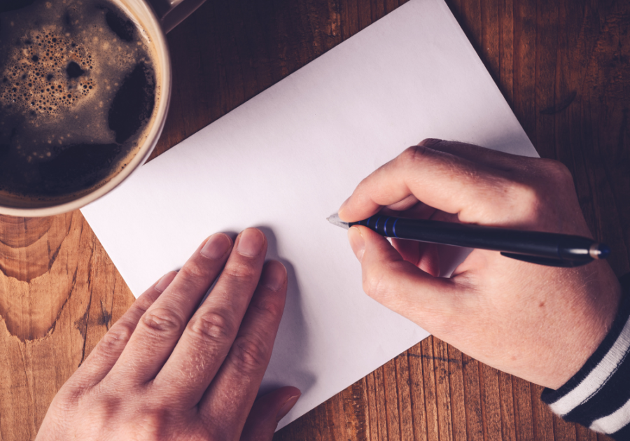 person's hands writing on paper Emotional Thank You Messages for Birthday Wishes