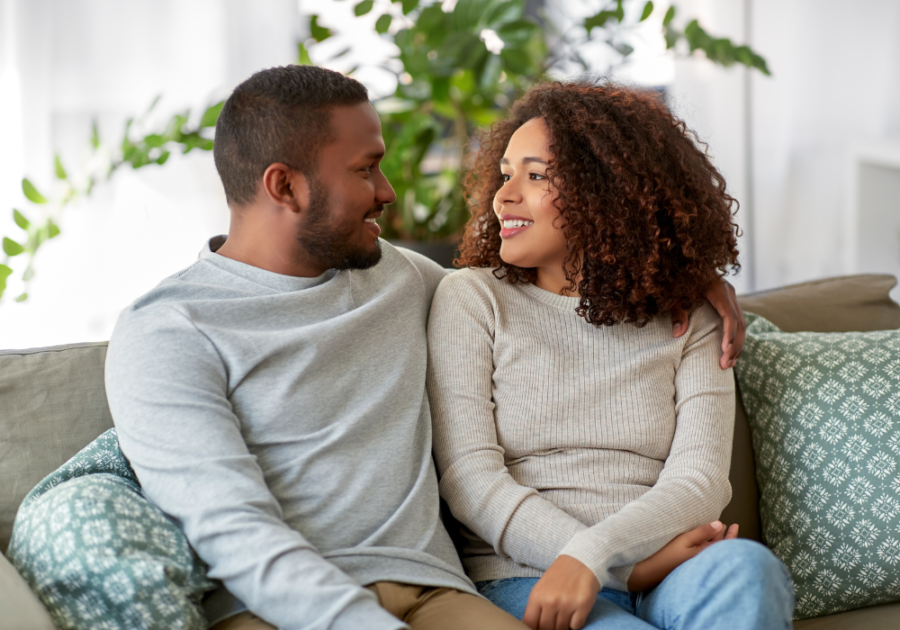 sweet married couple sitting on the couch trick questions to ask your boyfriend