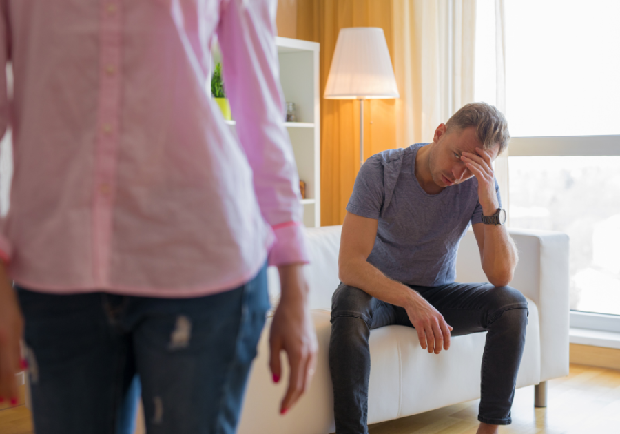 man sitting on the couch with hand in his head signs he never loved you