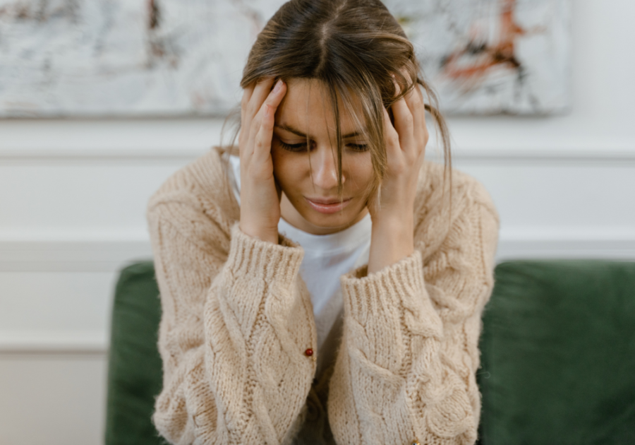 woman trying to massage the side of her head signs he never loved you