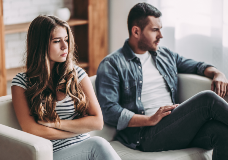 couple sitting on sofa sad Why Am I So Mean To My Boyfriend