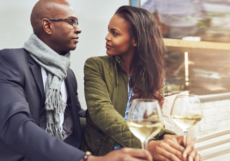 couple drinking wine and facing each other Ways a Cancer Man Tests You