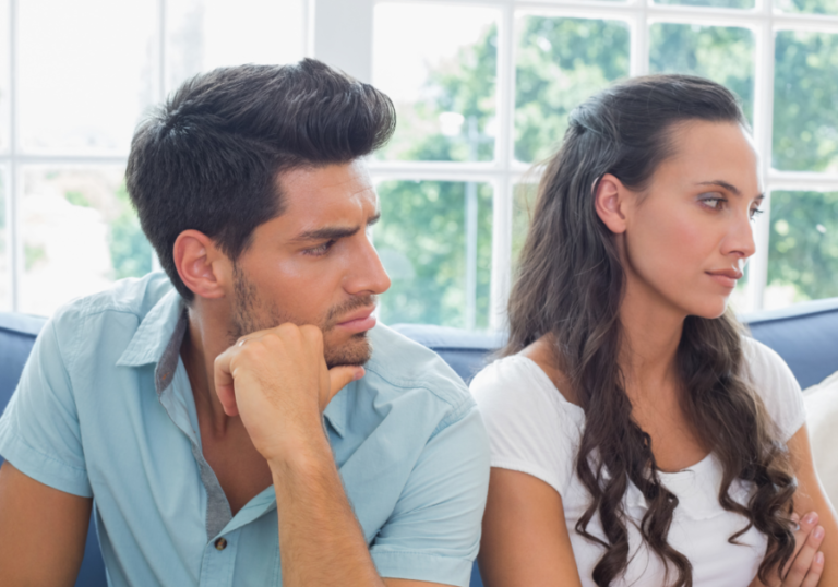 couple sitting together with sadness Early Signs of a Possessive Man