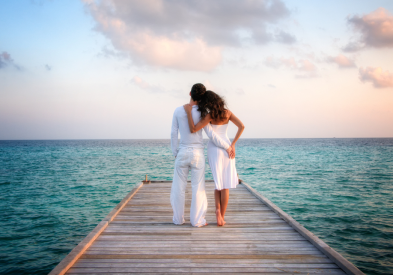 couple standing together looking at ocean Angel Number 555