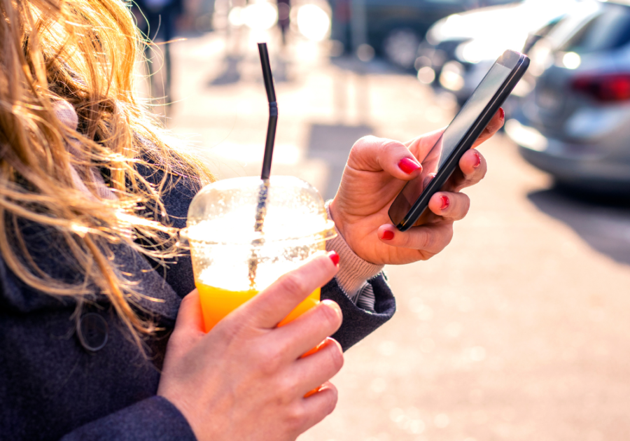 woman looking at phone How to Respond to 'I Miss You'