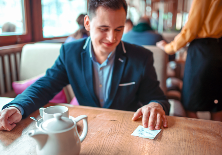 man reading note sitting a table Cute Notes to Write Your Boyfriend