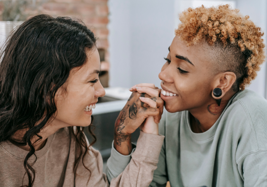 two women smiling holding hands Types of Lesbians