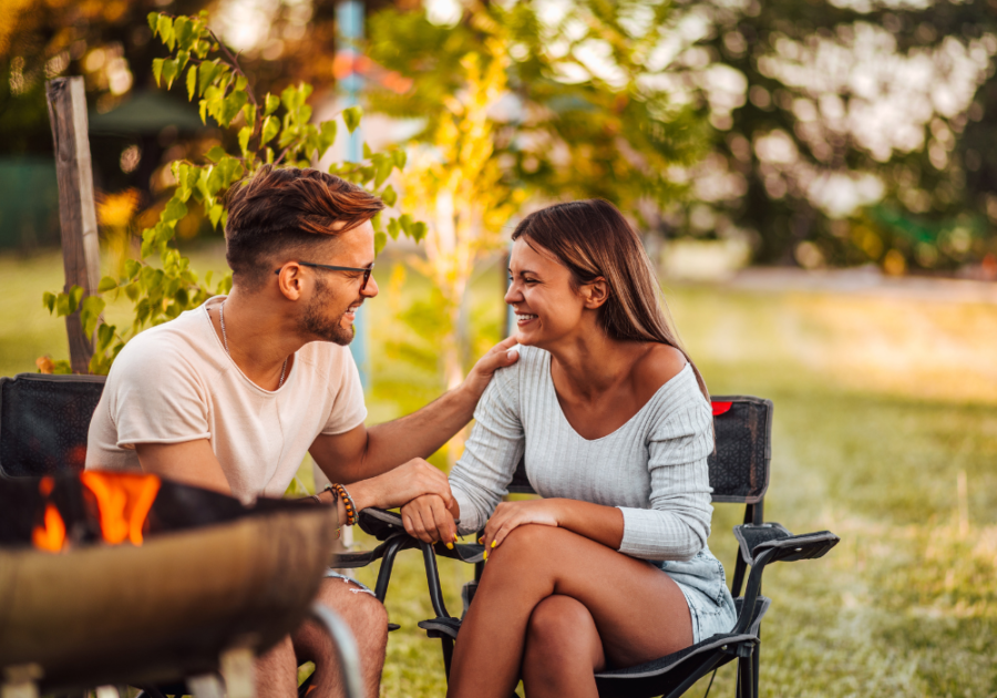 couple sitting outside talking Weird Questions to Ask a Guy