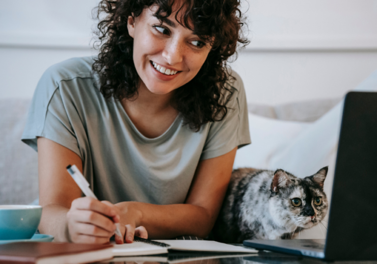 woman smiling writing note Cute Notes to Write Your Boyfriend