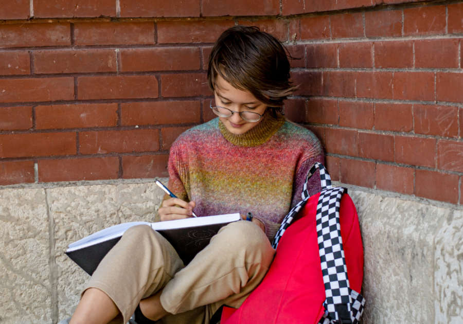 woman sitting alone writing introvert or extrovert quiz