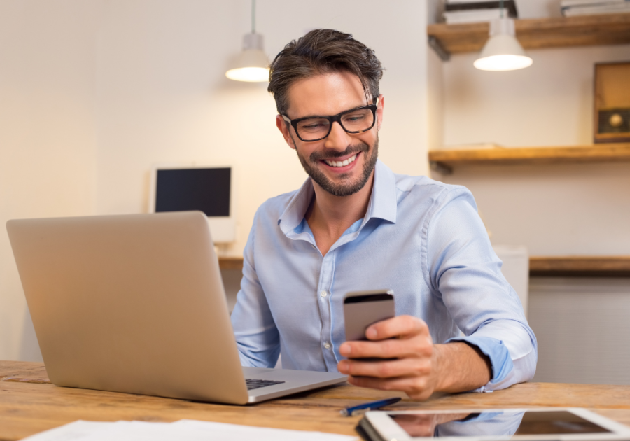 man sitting at desk smiling Funny Bumble Bio