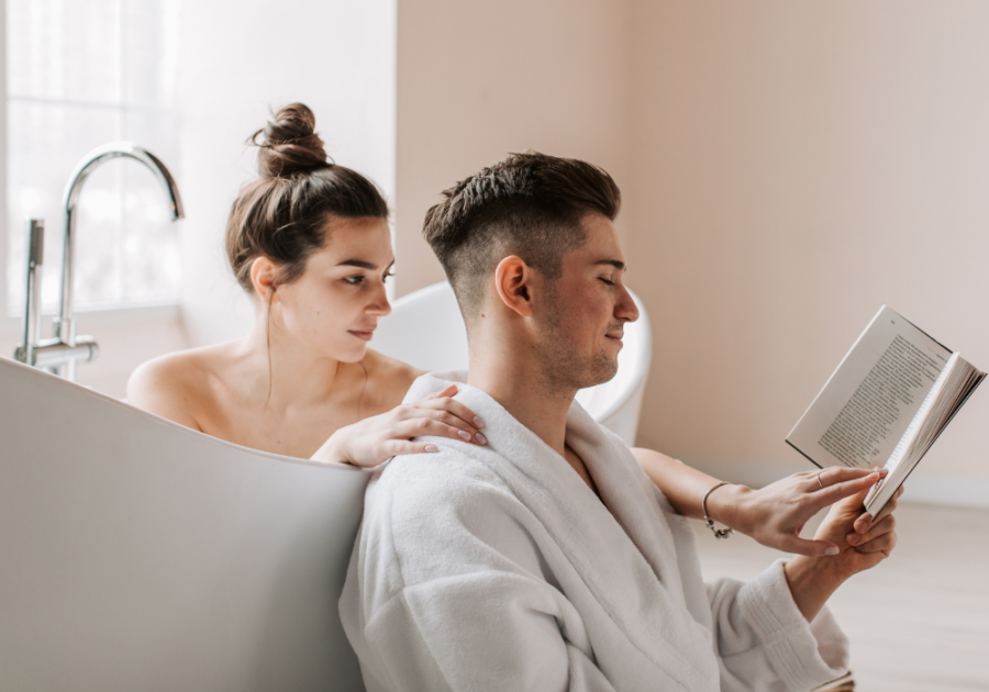 woman in tub man sitting on floor reading book What an Aquarius Man Needs in a Woman