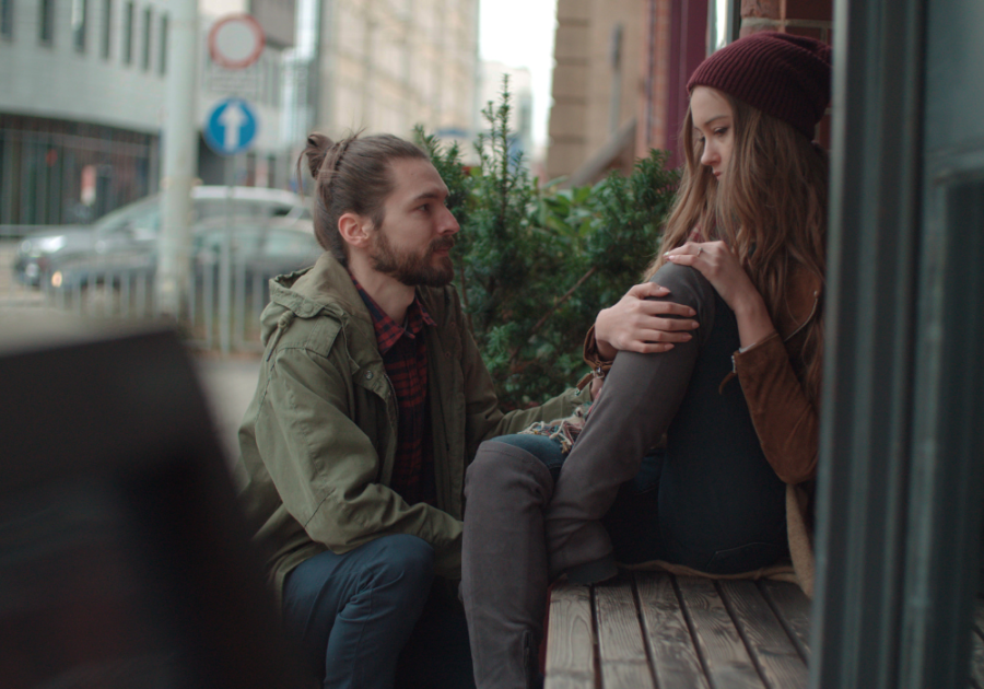 couple sitting outside on balcony How To Tell Someone You Just Want To Be Friends