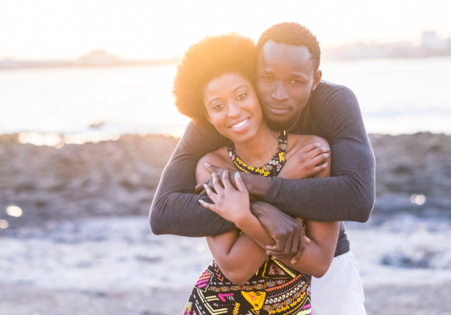 couple posing on beach hugging Virgo Man and Pisces Woman Compatibility