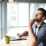 man sitting at desk thinking traits of a stoic personality