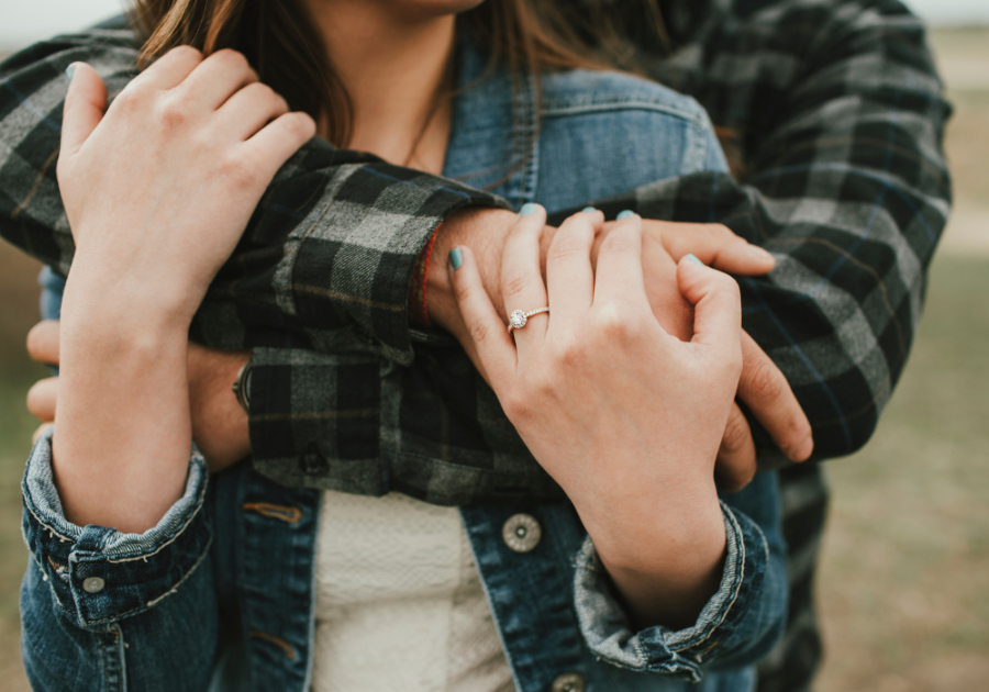 man hugging woman from behind Reassurance in a Relationship