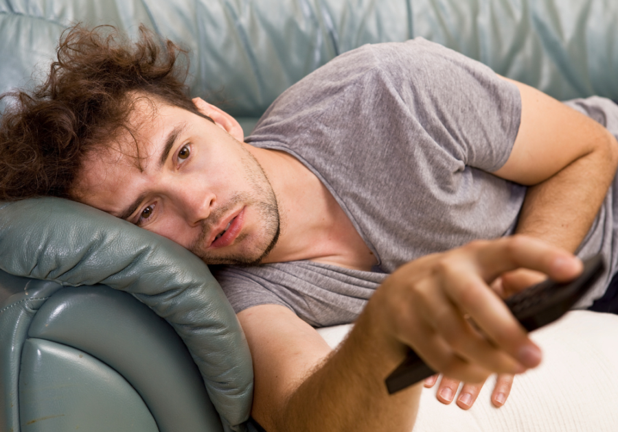 man laying on sofa with TV remote When Your Grown Child Breaks Your Heart