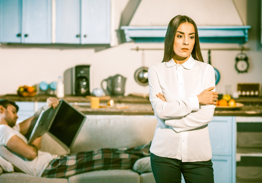 woman standing man in pajamas on sofa turned of by husband