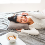 woman laying on bed talking on phone Long-Distance Relationship