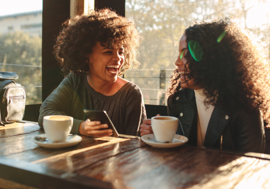 women laughing over coffee Funny Bumble Bio