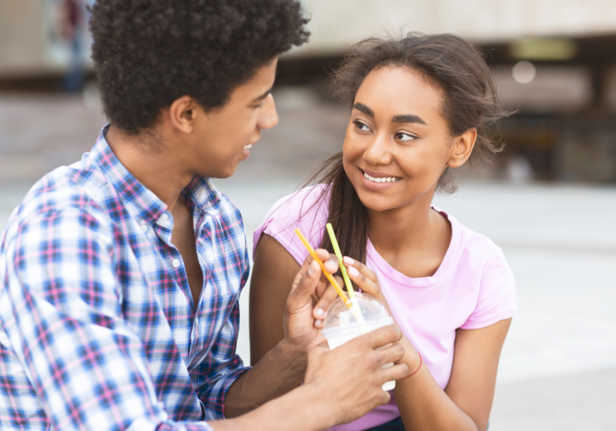 young couple sitting drinking with a straw dating apps for teenagers