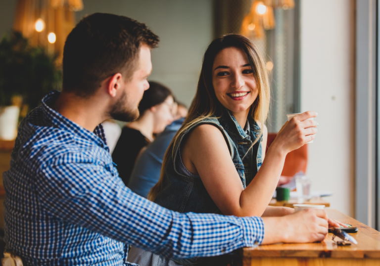 couple sitting at bar talking Keep a Conversation Going with a Girl