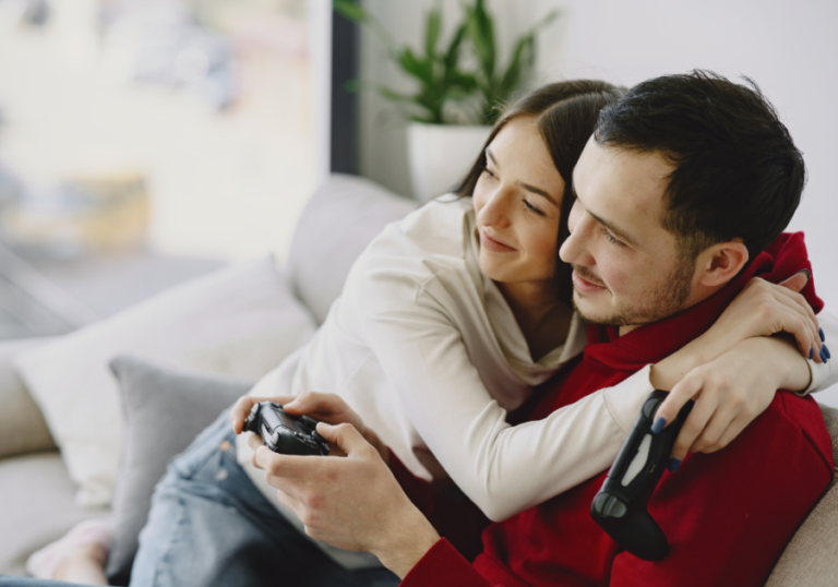 couple sitting on sofa hugging watching tv games to play with your girlfriend