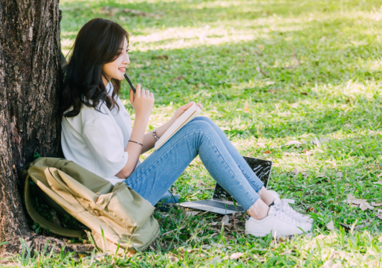 woman sitting by tree writing Love Poems For Crush