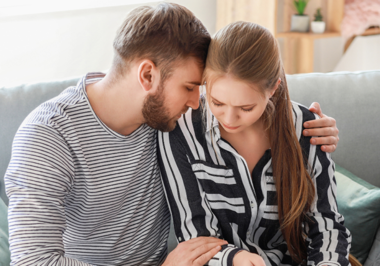 man consoling woman sitting on sofa Daddy Issues Quiz