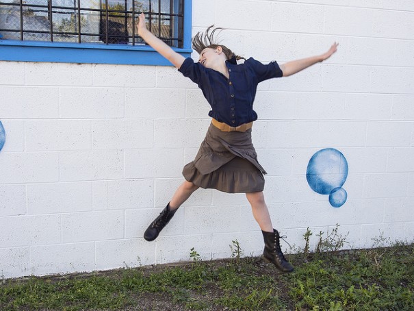 woman jumping up Uplifting compassion quotes