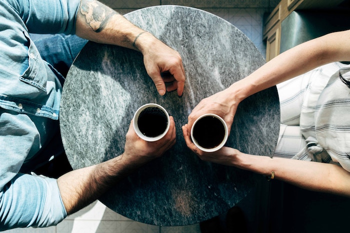 man and woman having coffee conversation starters