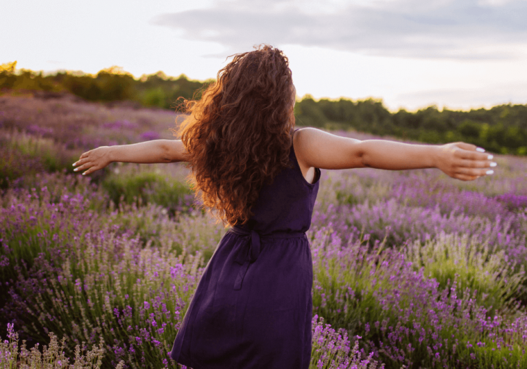 woman in field with arms out, letting go quotes