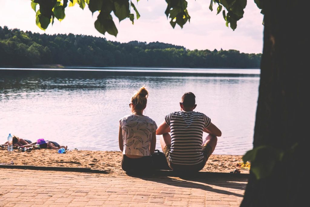 couple sitting beside lake How to Get Over A Breakup