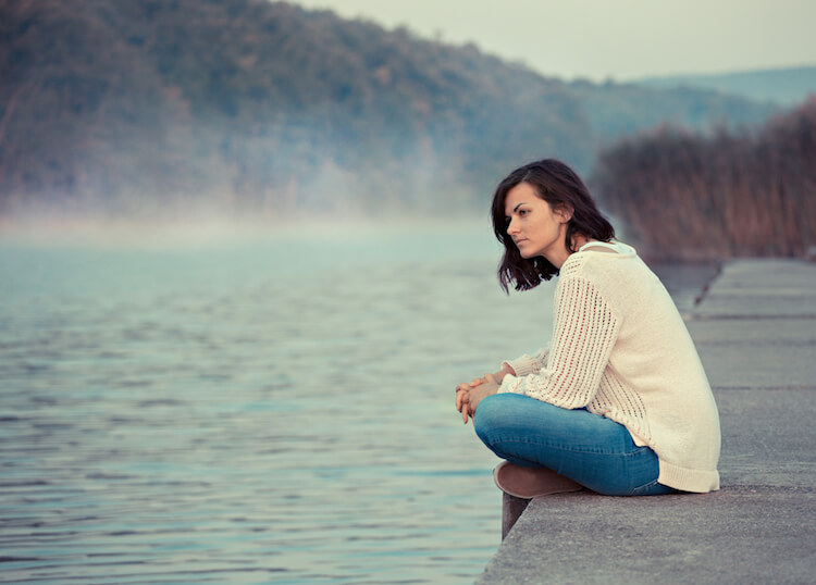 lonely woman sitting on dock what is an introvert