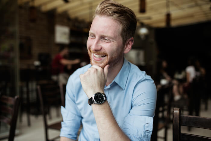 Redheaded man smiling how to love yourself