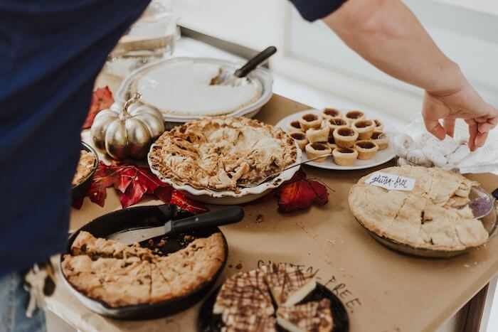 man at table of pies things to be thankful for