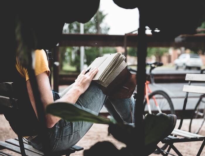 man sitting outside with diary journaling ideas