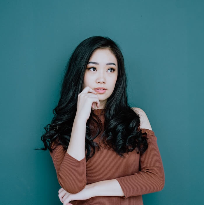 woman leaning on green wall introverted intuition