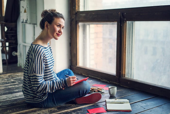 woman sitting on floor with journal diary journaling ideas