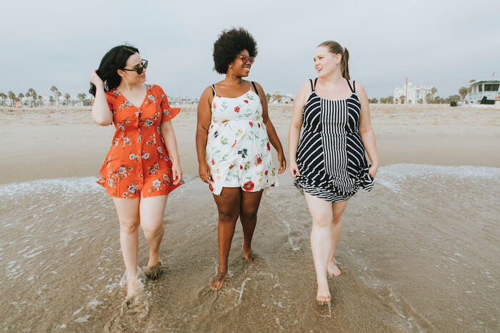 women walking along beach women outside laughing best Compliments