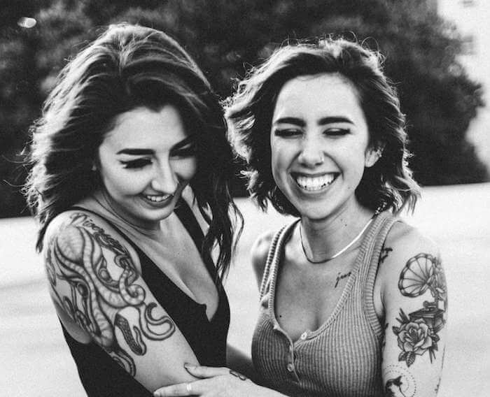 women laughing with tatoos laughing best compliments