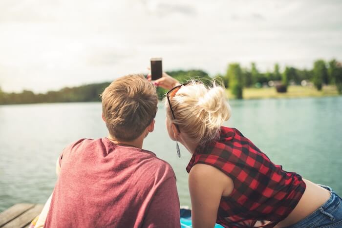 couple taking selfie at lake date ideas