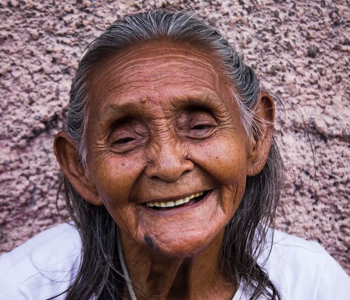 older woman leaning on wall inner strength