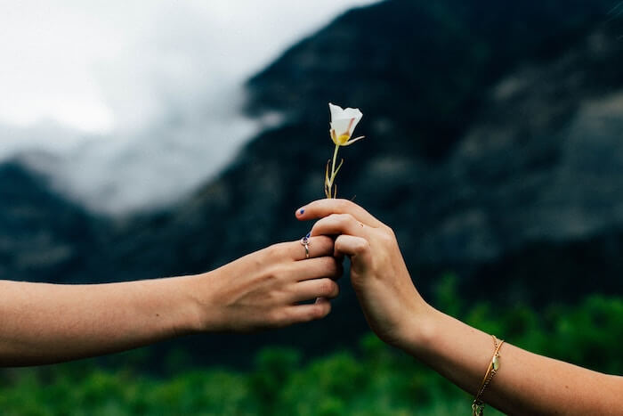 man giving woman flower personal qualities