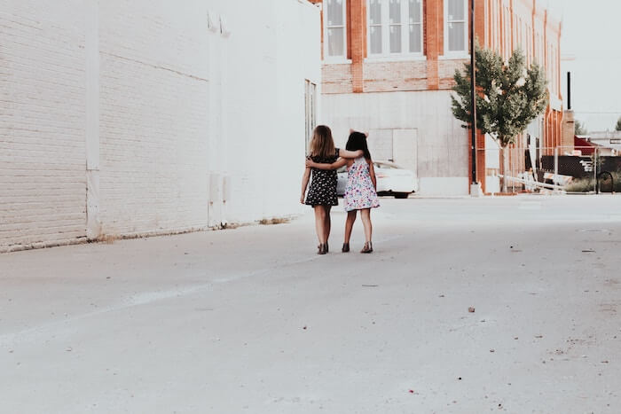 young girls walking and hugging personal qualities