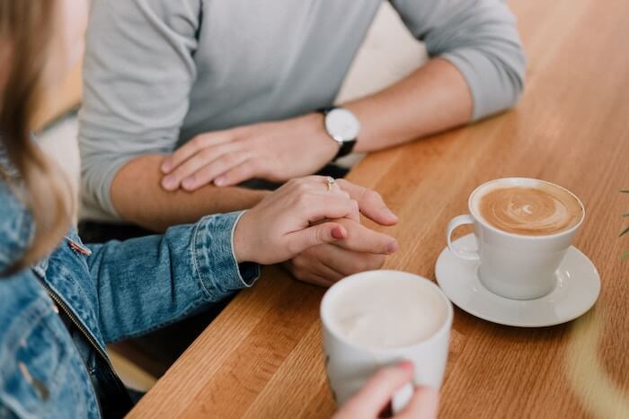 couple holding hands with coffee how to build trust