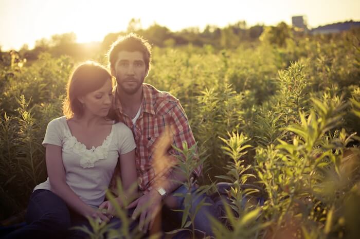 couple sitting in field of flowers Relationship Quizzes